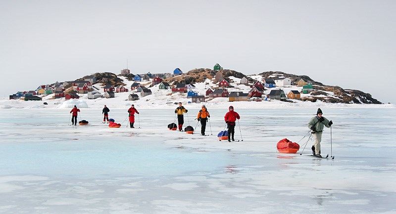 Cross-country skiing in east Greenland, a group skiing on frozen water with Icelandic Mountain Guides