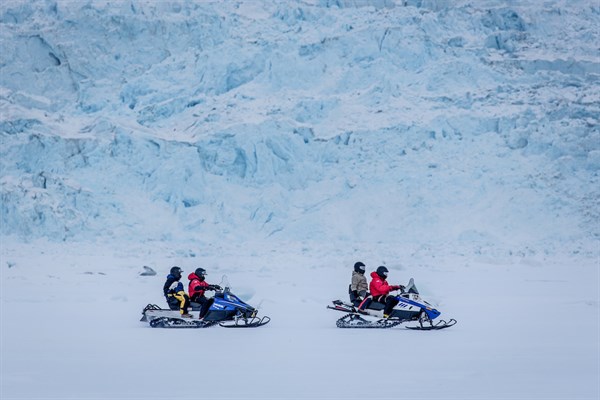 A Snowmobile Trip Along A Glacier Wall Near Ilulissat In Greenland