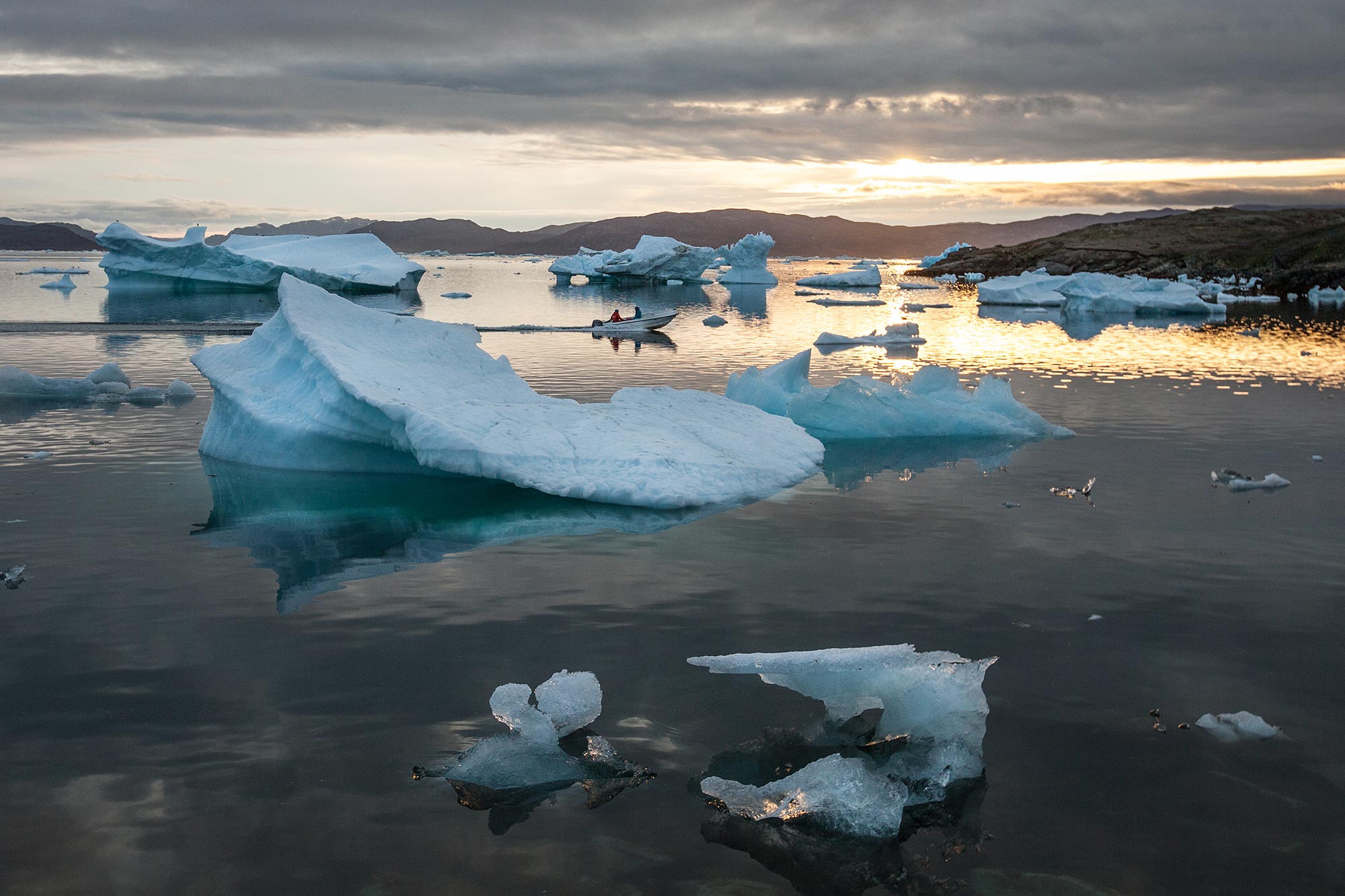 Icebergs on the beach at sunset in Greenland